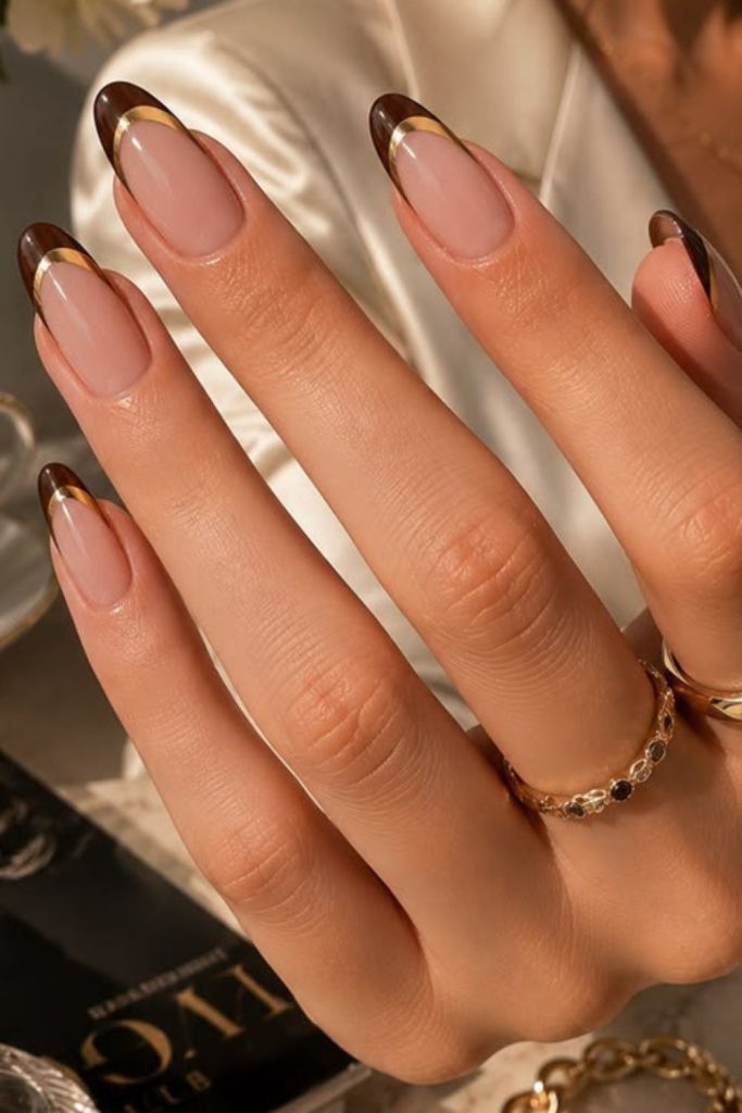 Cocoa chrome French tip nails.