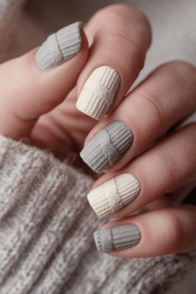 Cozy patchwork sweater nail design.
