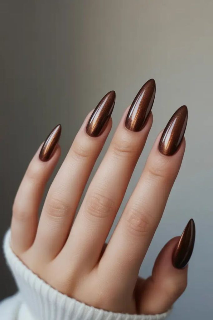 Dark cocoa chrome manicure design.