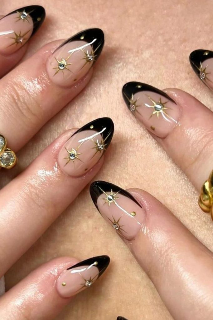 Black French tips with moon accents.
