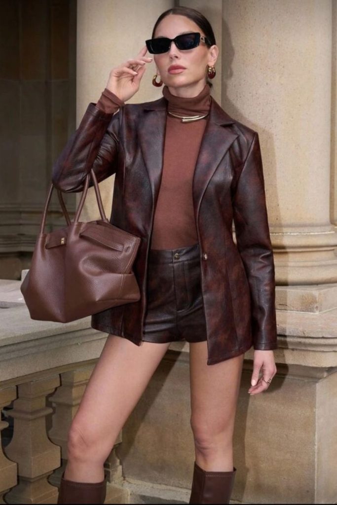 Espresso turtlenect tucked in leather skirt.