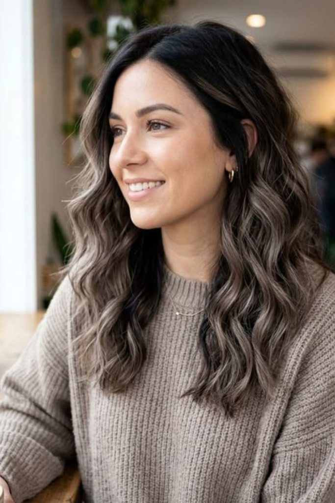 Espresso mushroom brown hair with glossy waves.