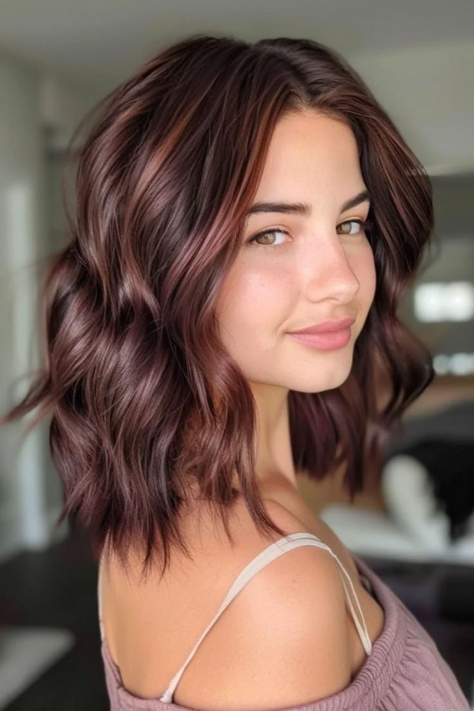 Espresso strawberry brunette hair with accents.