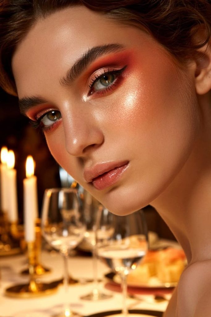 Fiery peach glow makeup look.