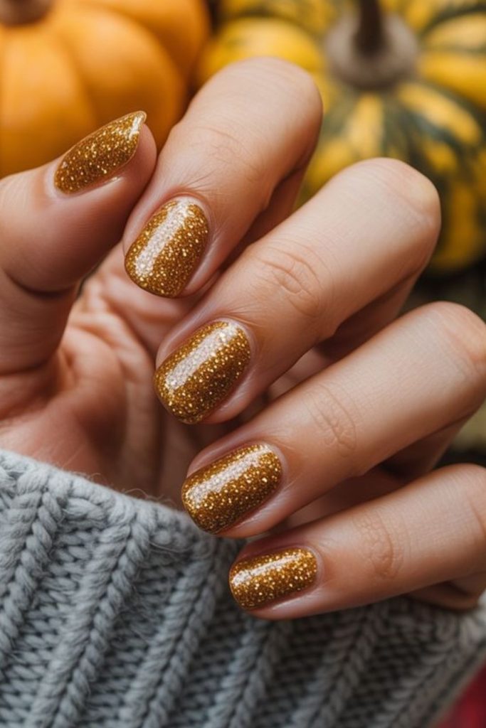 Golden pumpkin dust Thanksgiving nails.