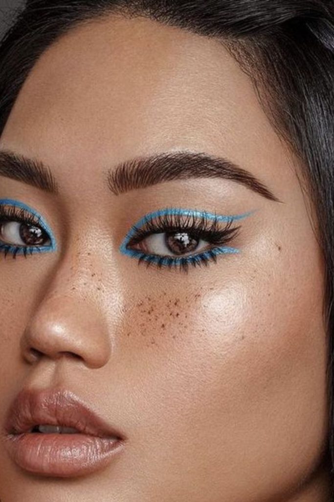 Graphic blue eyeliner eye makeup.