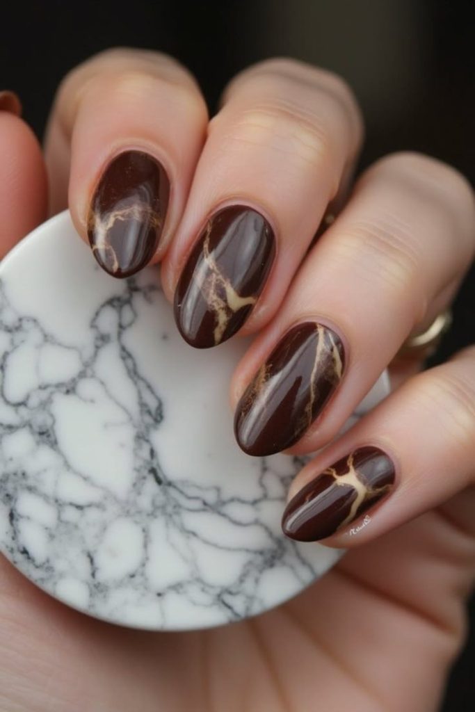 Luxe chocolate marble nail design.