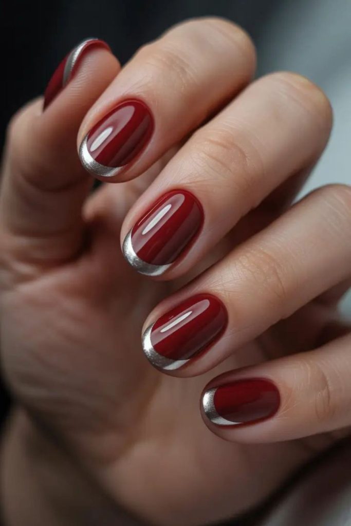 Metallic oxblood French tip nails.