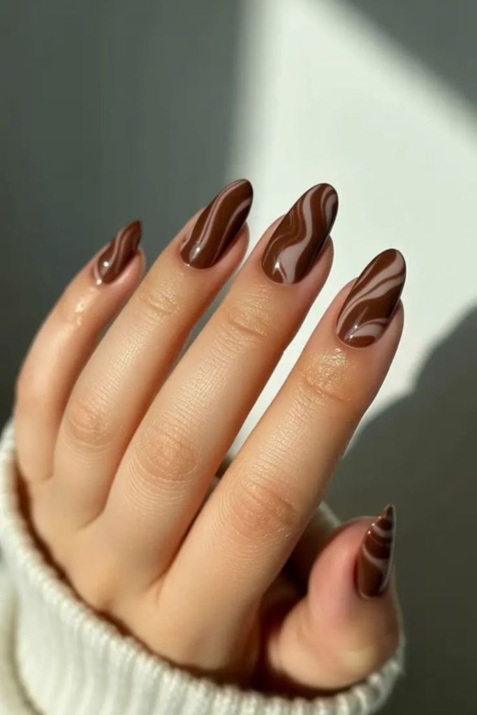 Milk chocolate swirl manicure design.