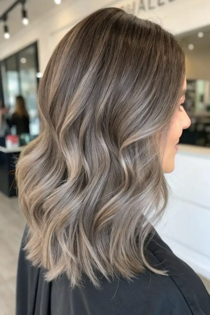 Mushroom brown hair with face-framing highlights.