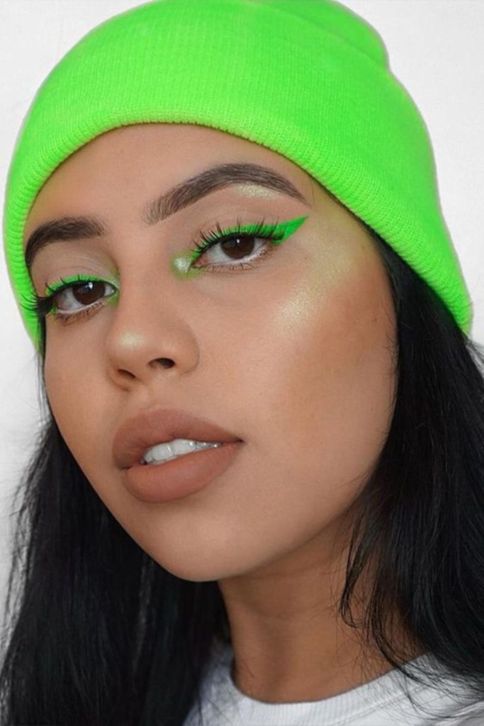 Neon inner corner eye makeup.