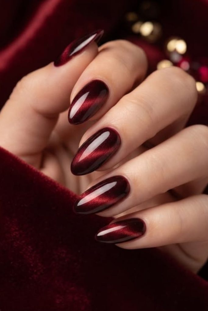 Magnetic oxblood cat-eye manicure design.