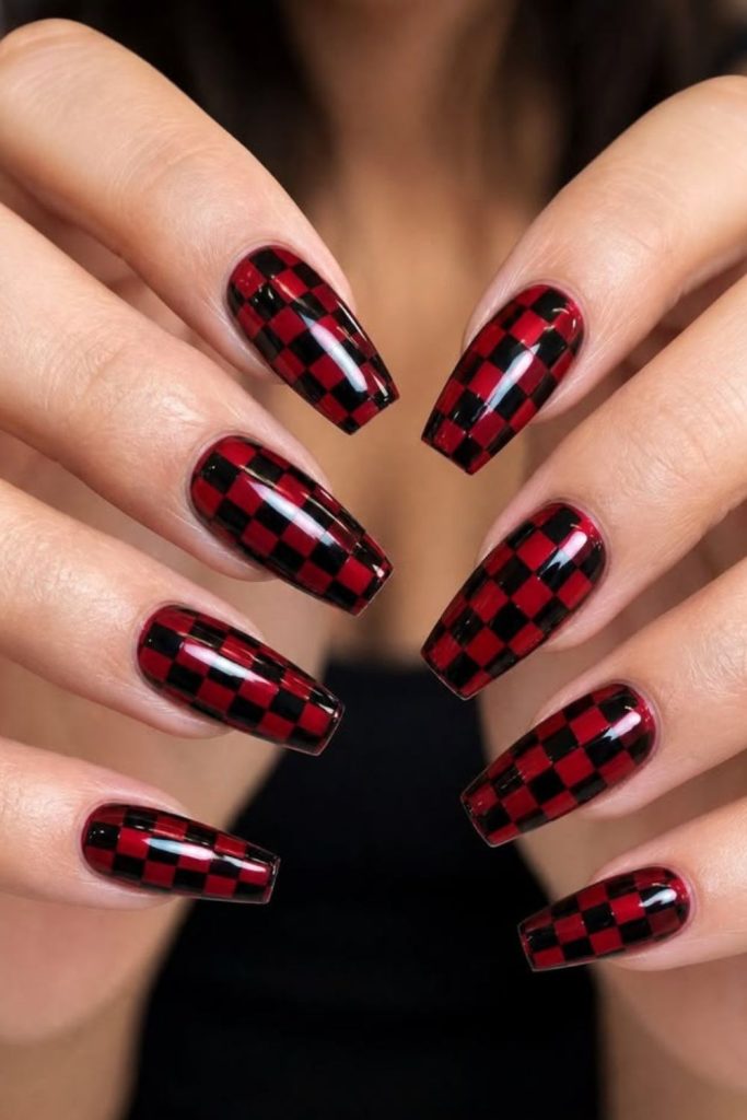 Playful oxblood checkerboard manicure design.