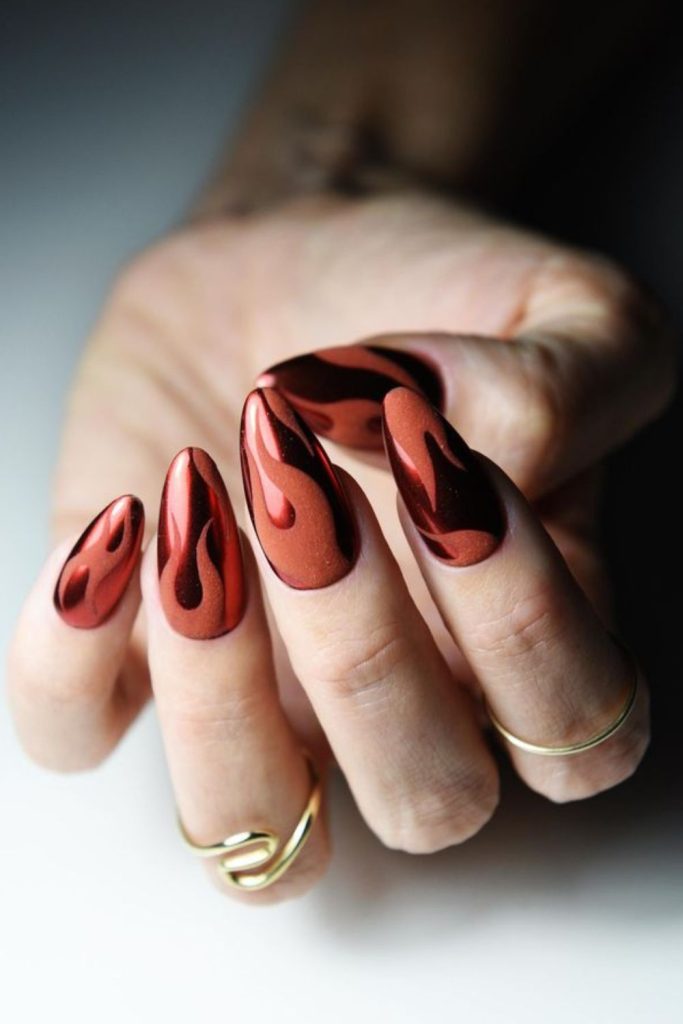 Chrome flame oxblood statement nails.
