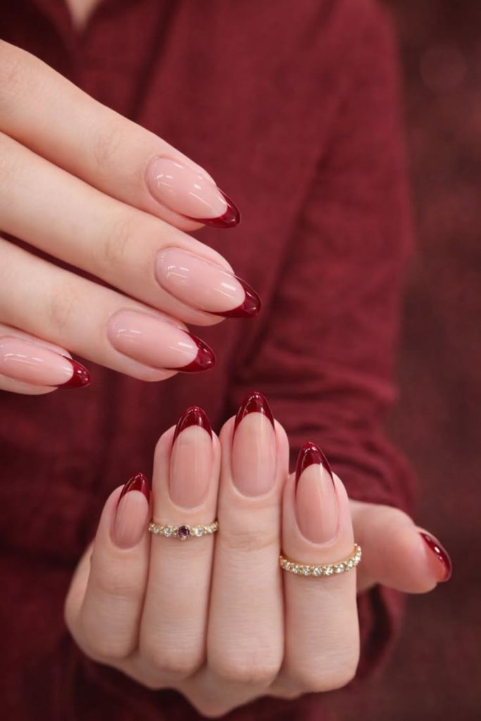 Sheer nails with oxblood French tips.