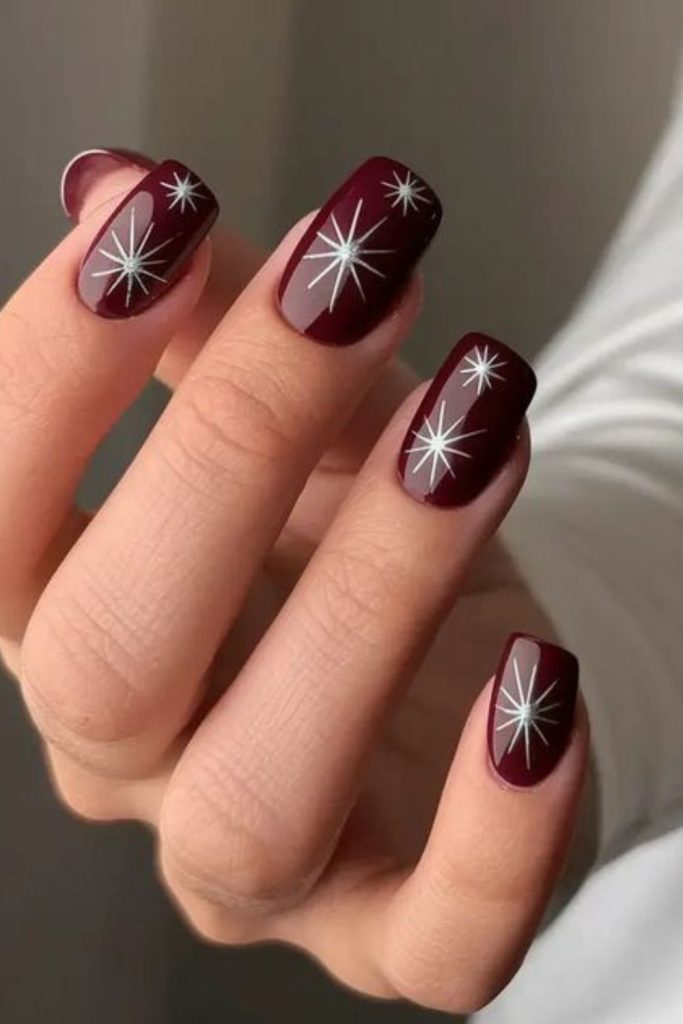Velvet oxblood celestial star nails.