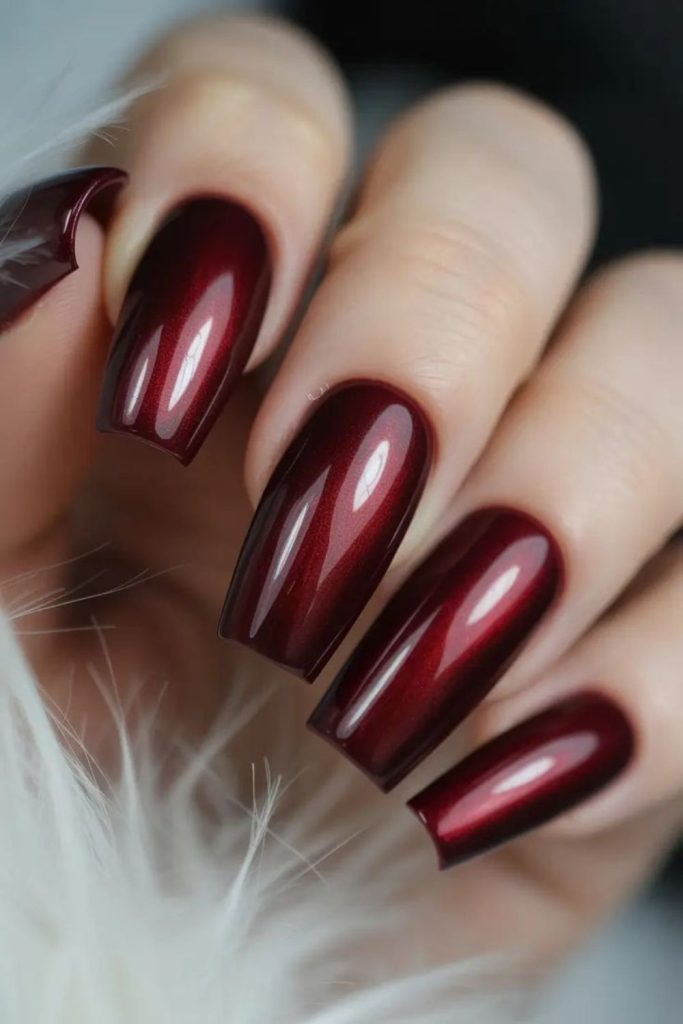 Pearlescent oxblood almond nail design.