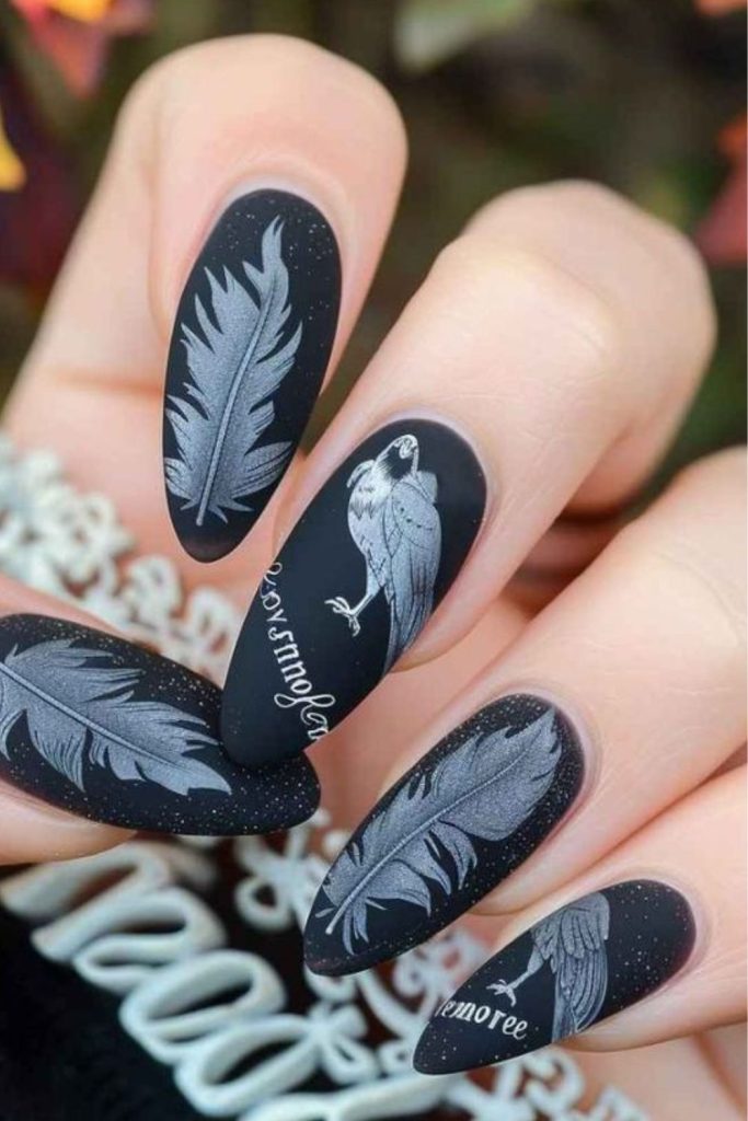Raven feather nails with celestial accents.