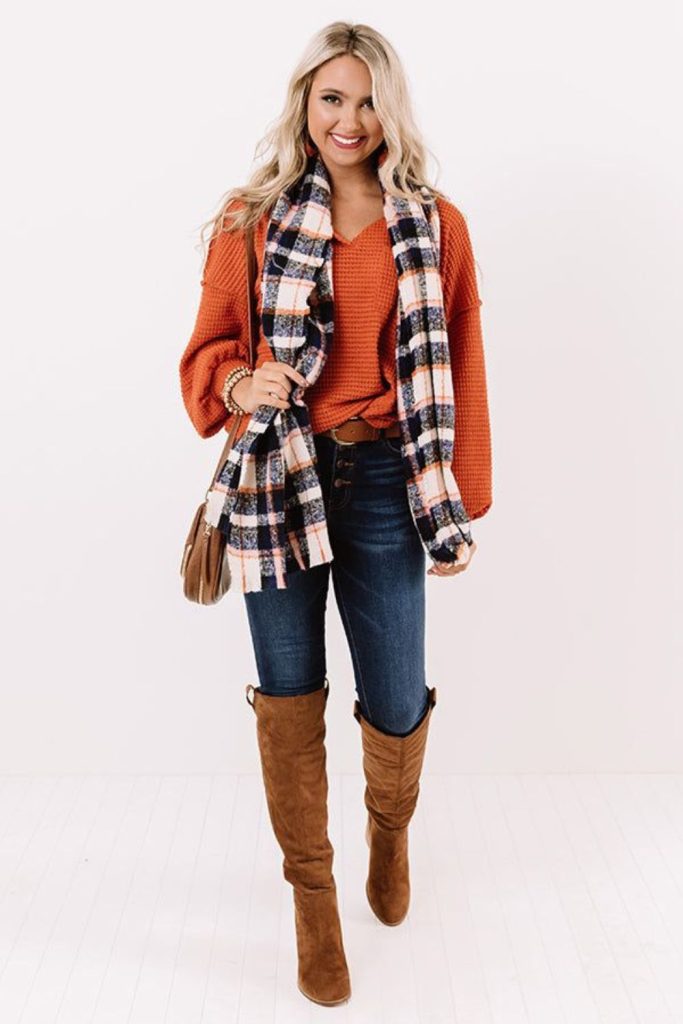 Plaid shirt with bootcut jeans.