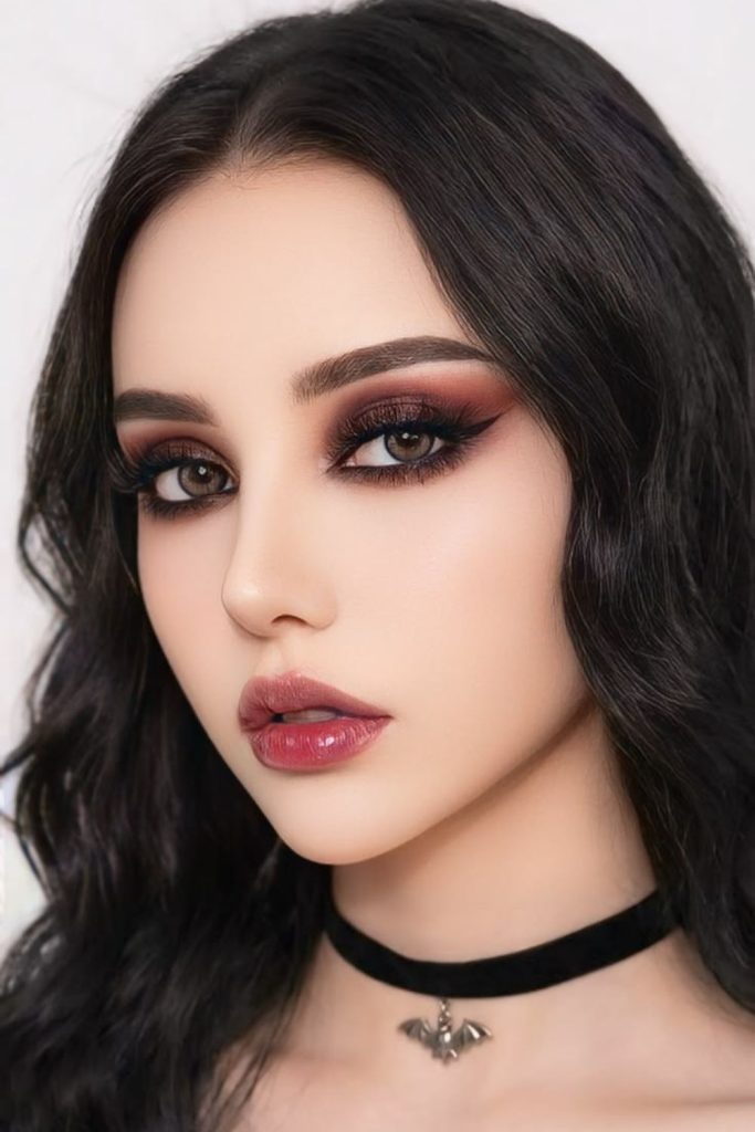 Smoky blackberry eyes with dark lipstick.