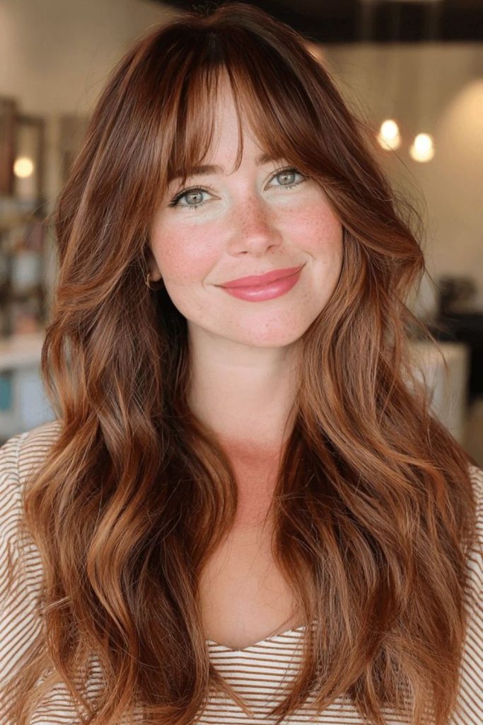 Strawberry brown balayage with warm highlights.