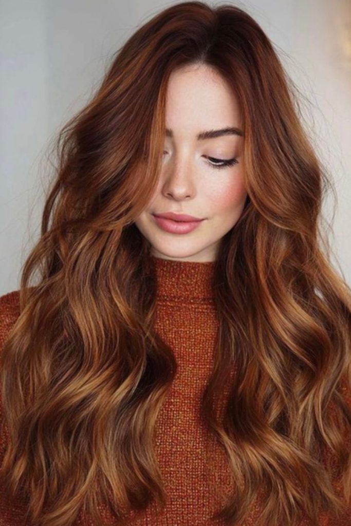 Strawberry hazelnut brunette hair with waves.