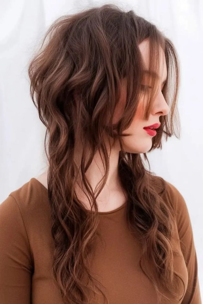 Tousled brunette jellyfish haircut with layers.