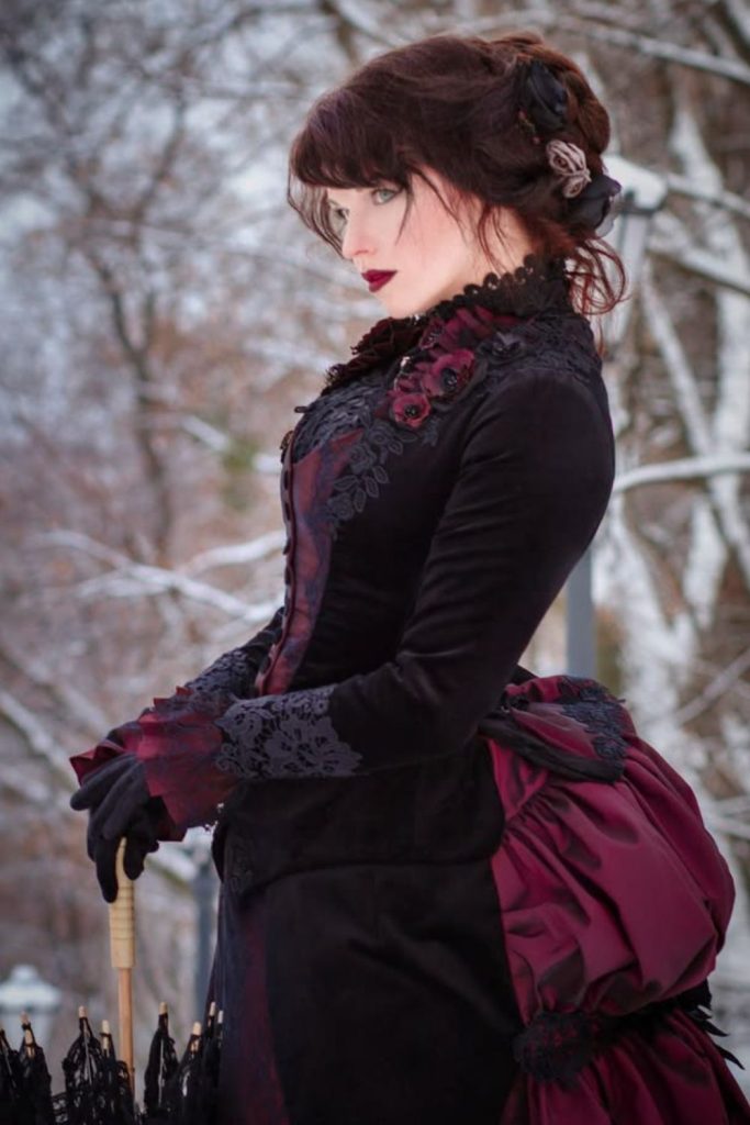 Victorian vampire costume with crimson hair.