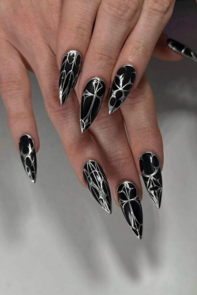 Chrome nails with wicked spiderweb designs.