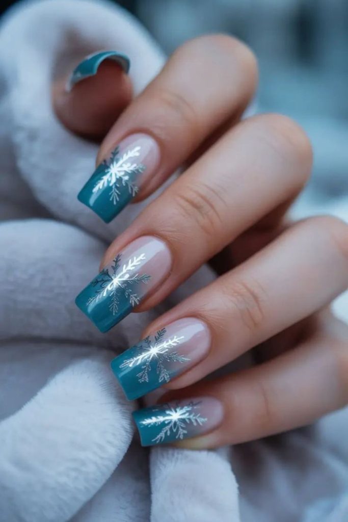 Arctic teal aurora snowflake nails.