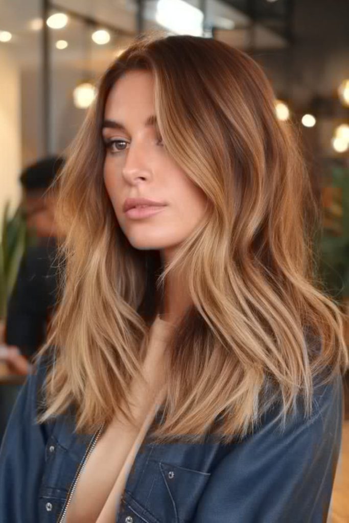 Bronde sunset hair with warm blended highlights.