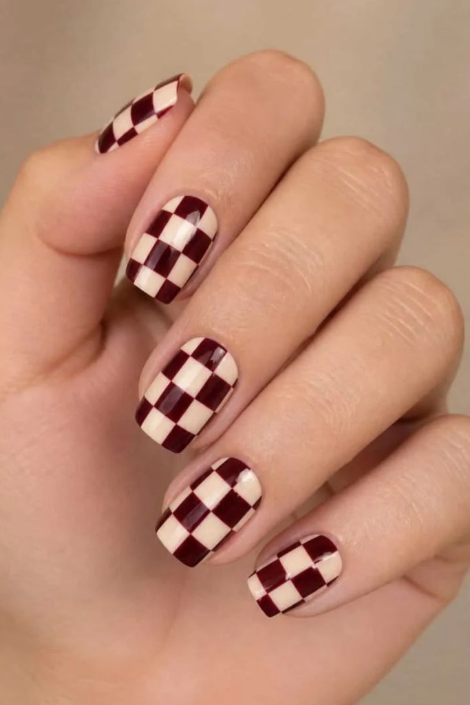 Burgundy velvet checkerboard nail design