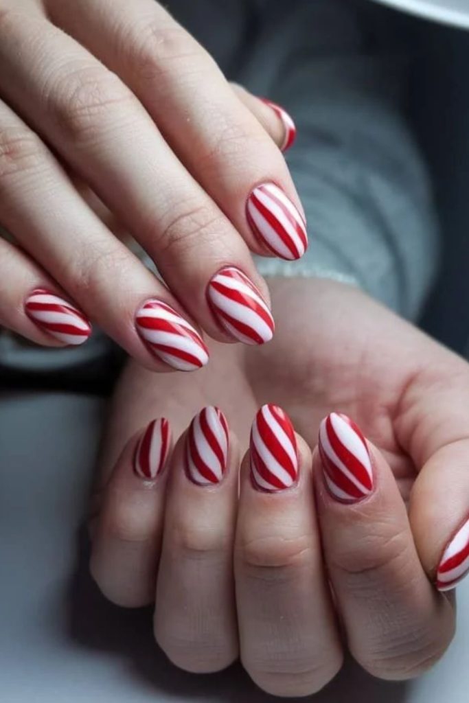 Modern candy cane aura winter nails.