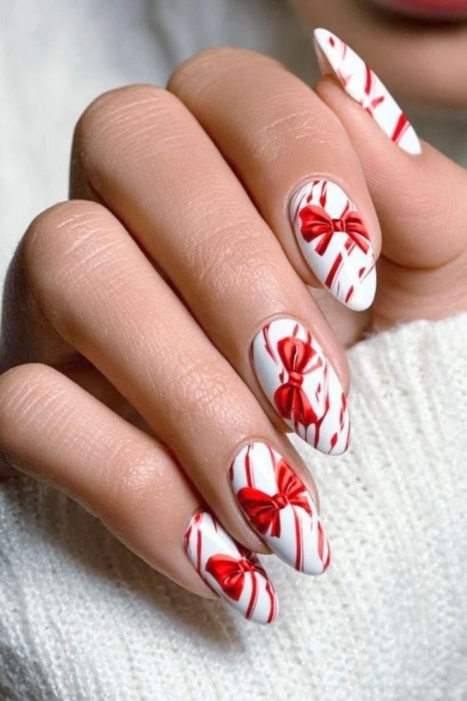 Adorable candy cane bow Christmas nails.