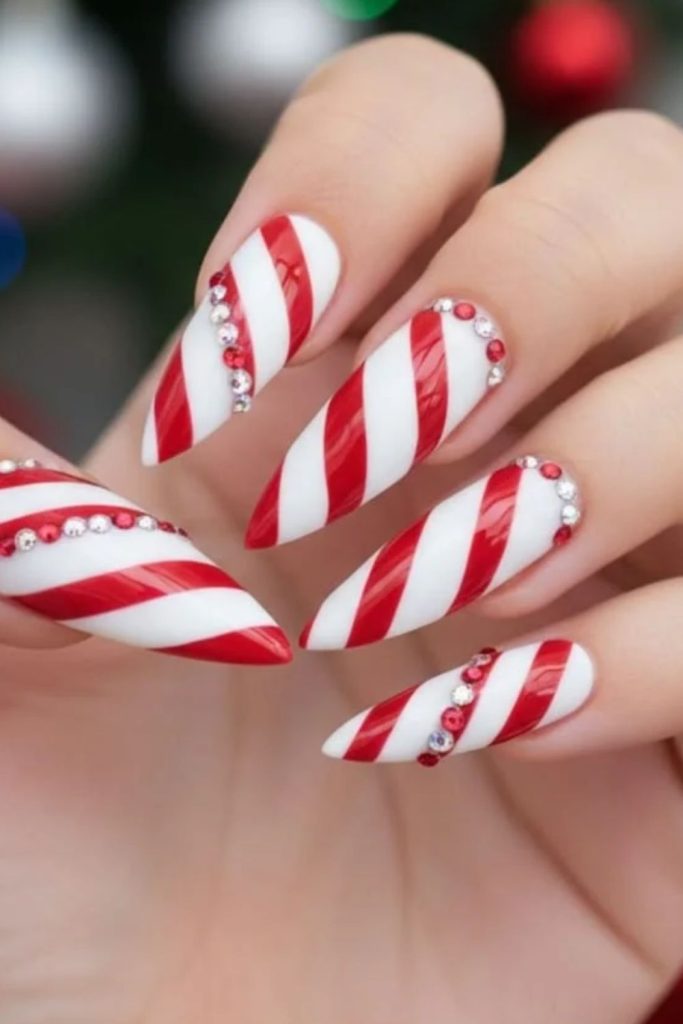 Glamorous jeweled candy cane nail design.