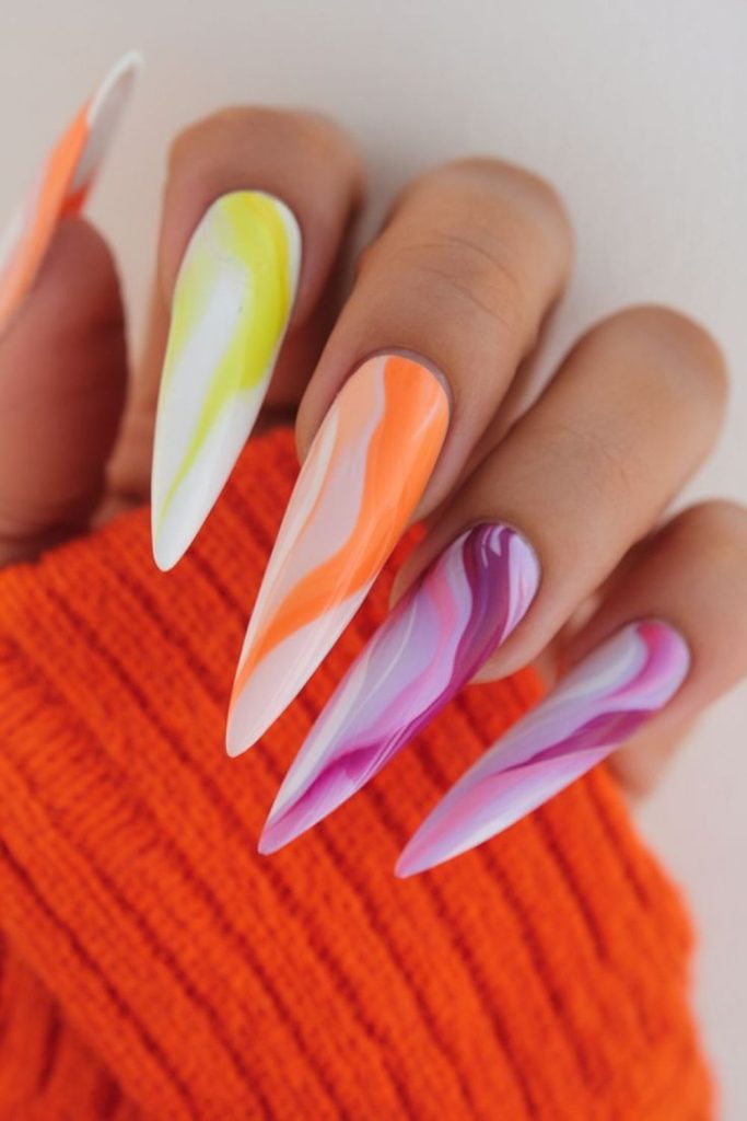 Colorful pastel swirl stiletto nails.