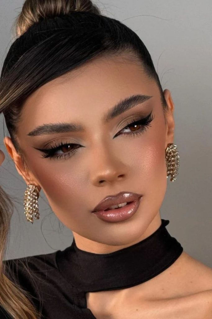 Caramel warm cat-eye siren makeup look.