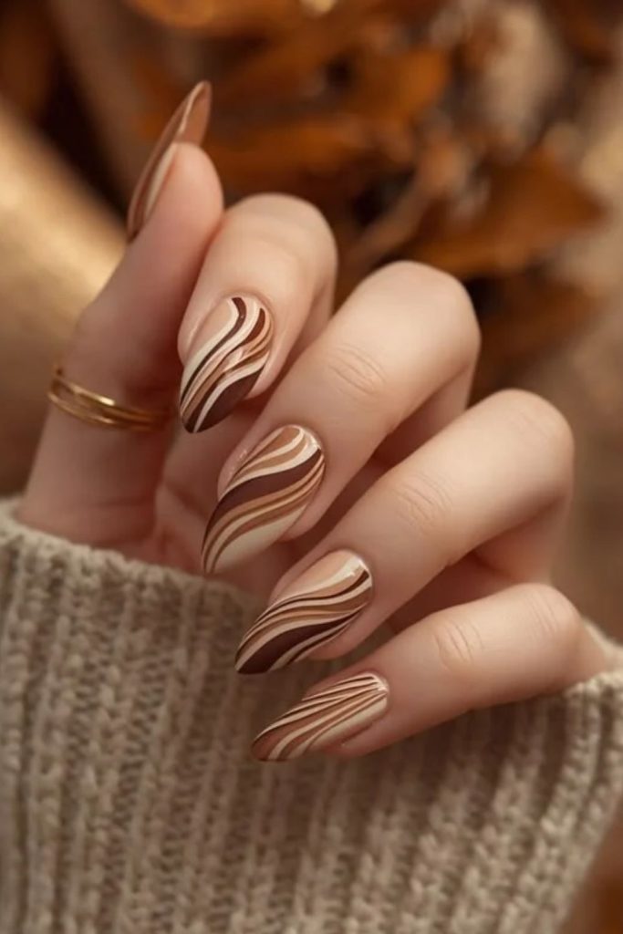 Caramel and chocolate swirl nail design.