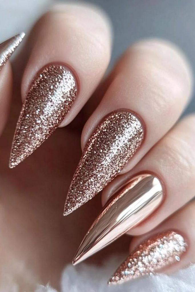Champagne glitter pointed stiletto nails.