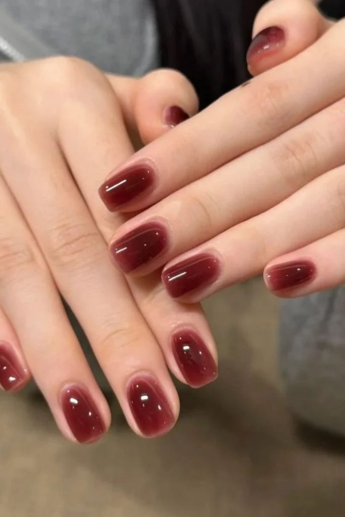 Glossy cherry cola jelly nails.