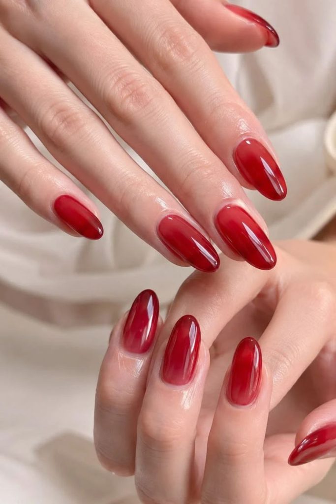 Translucent cherry red glass nails.