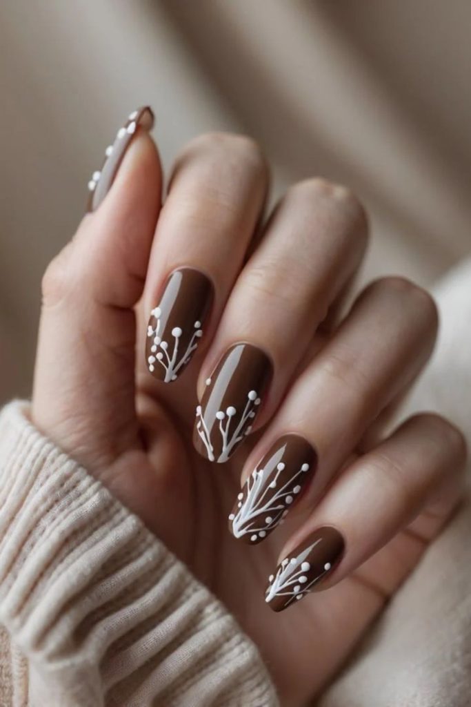 Chocolate nails with snowy white accents.