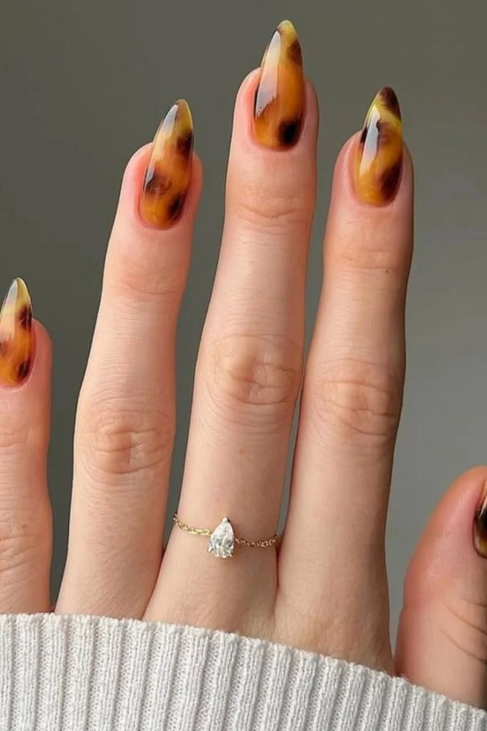 Classic caramel tortoiseshell polished nails.