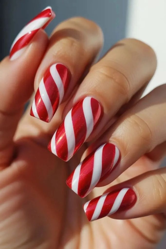 Classic red and white peppermint swirl nails.
