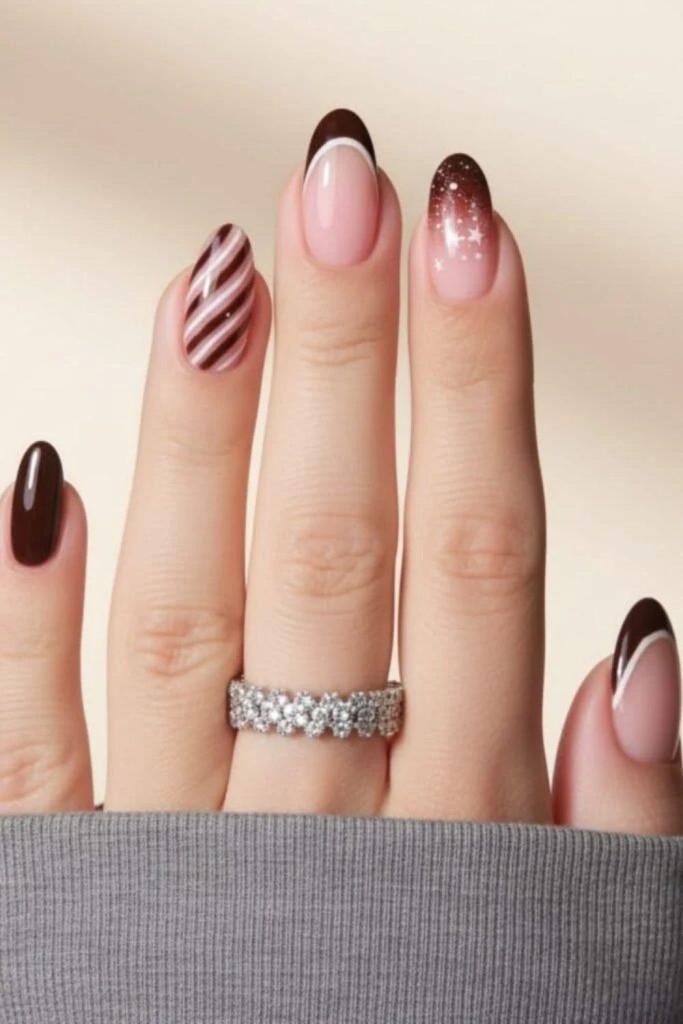 Chocolate nails with candy cane French tips.