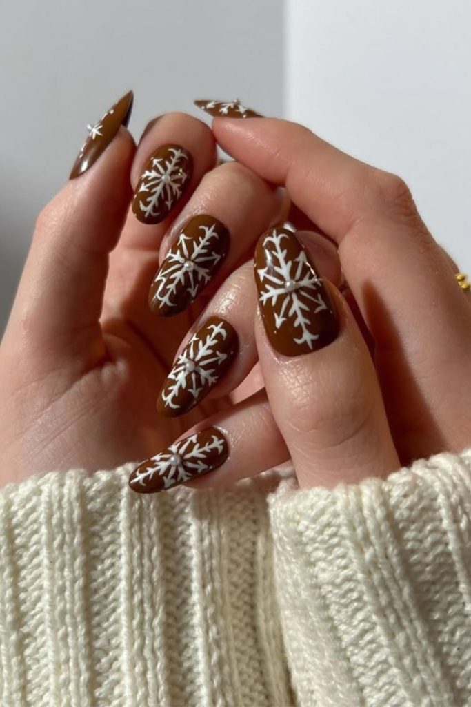 Cozy mocha cream snowflake nails.