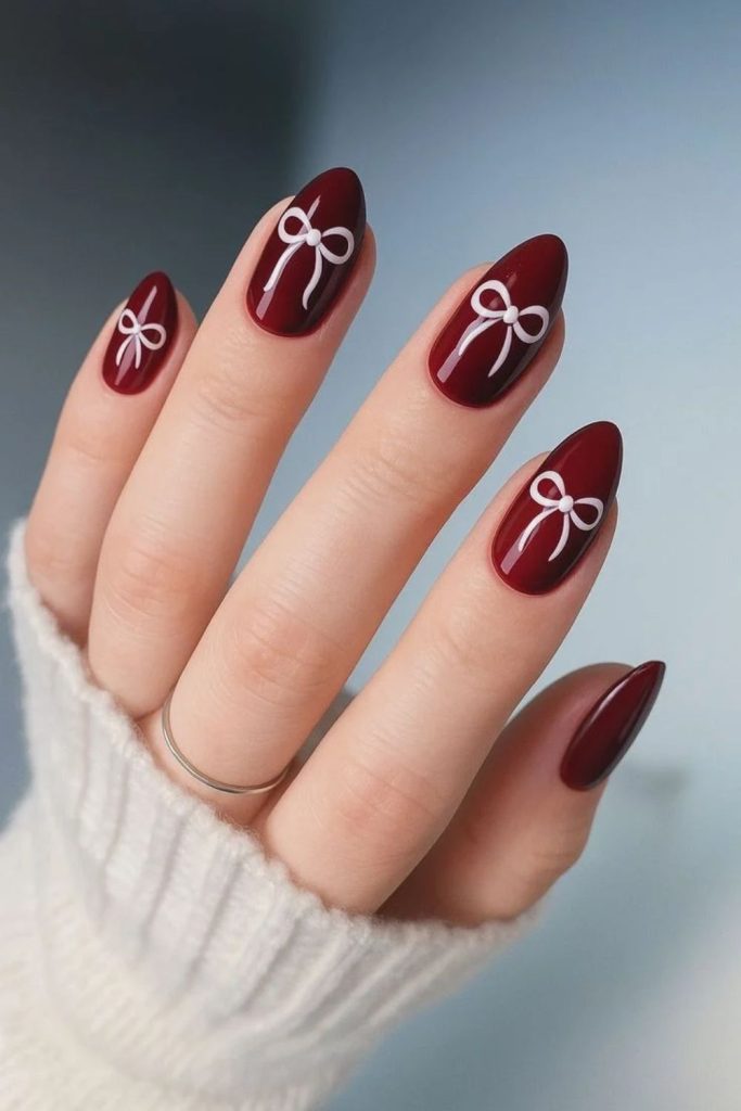 Cranberry bow and pearl nails