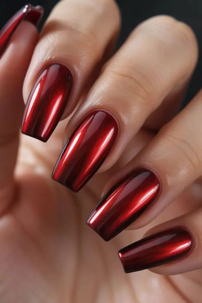 Shimmering cranberry chrome manicure nails