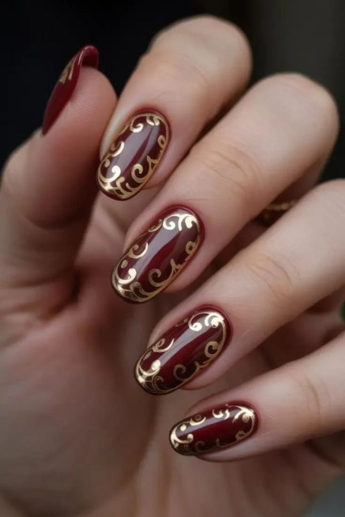 Cranberry nails with gold filigree