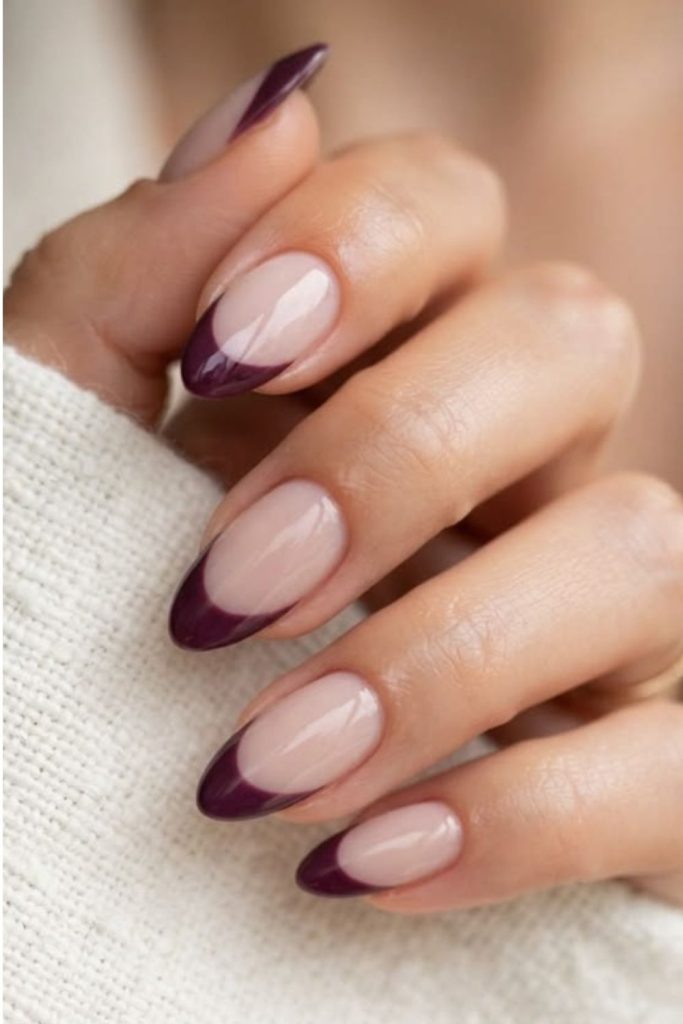 Deep plum French tip manicure.